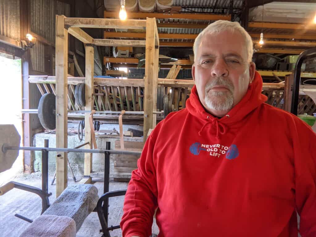 Zak wearing his Never Too Old to Lift Hoodie